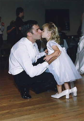 little girl wearing bride's shoes